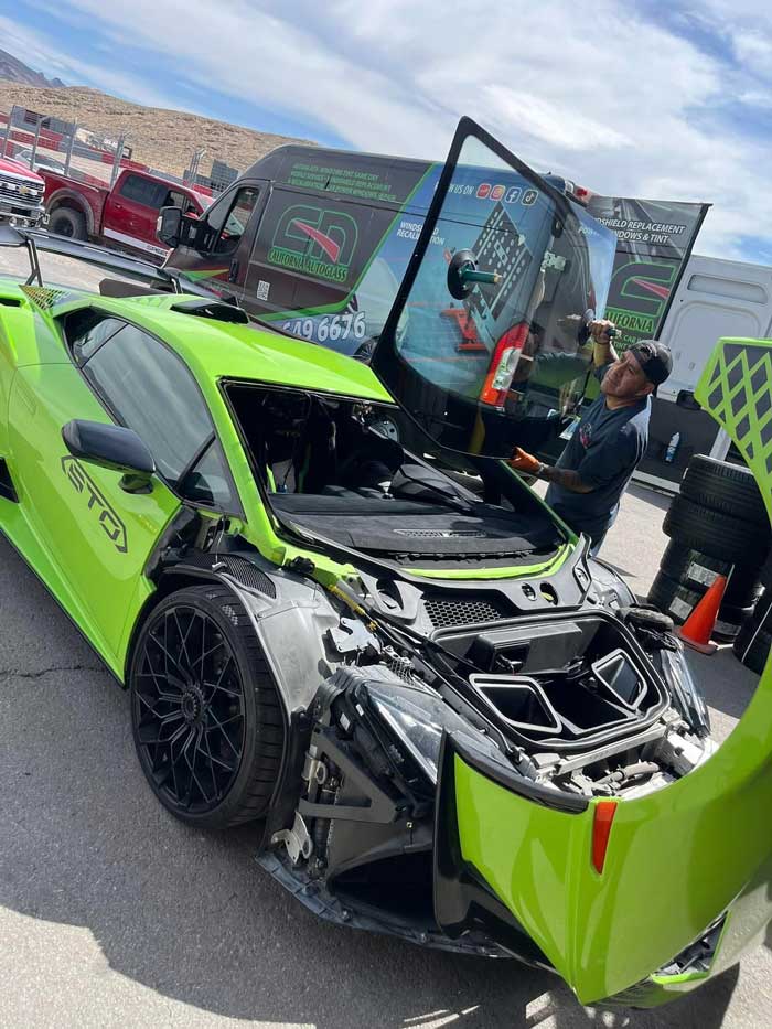 C.A. Auto Glass technician replacing windshield glass on a luxury vehicle in Las Vegas