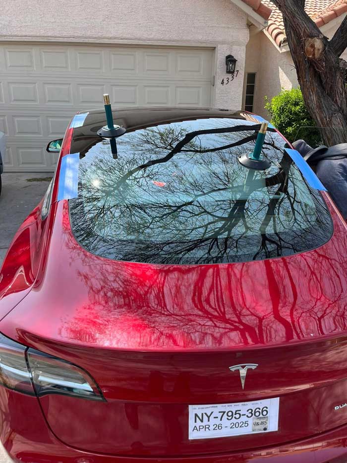 Rear windshield replacement on red vehicle